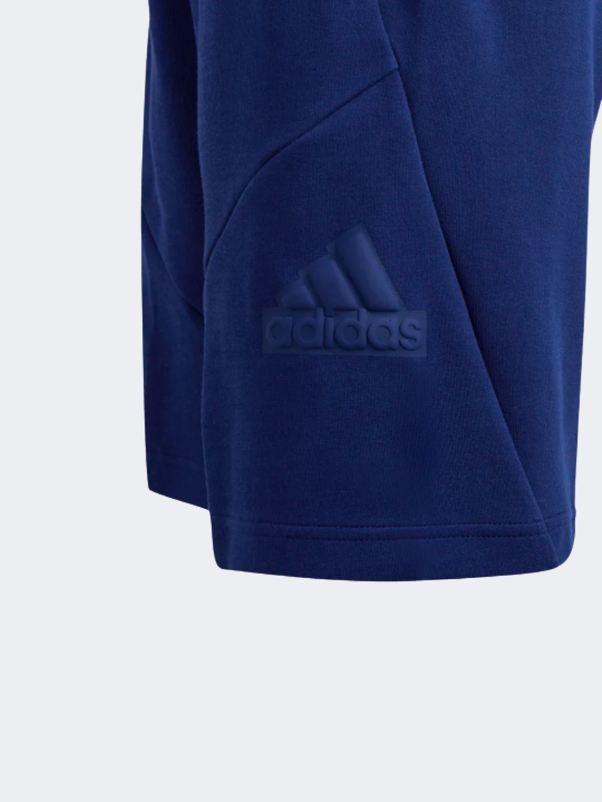 شورت رياضي للأولاد مقاس 8 إنش بشعار Adidas Future Icons باللون الأزرق الداكن